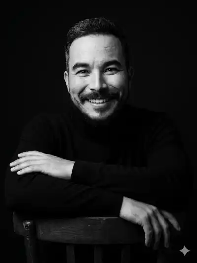 studio portrait of him leaning gracefully on the backrest of a chair,